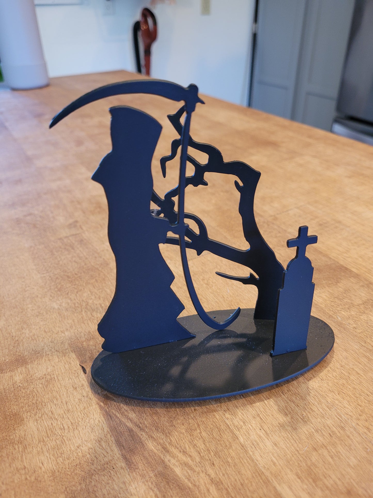 Sculpture - Grim Reaper in the old cemetery/ small tree